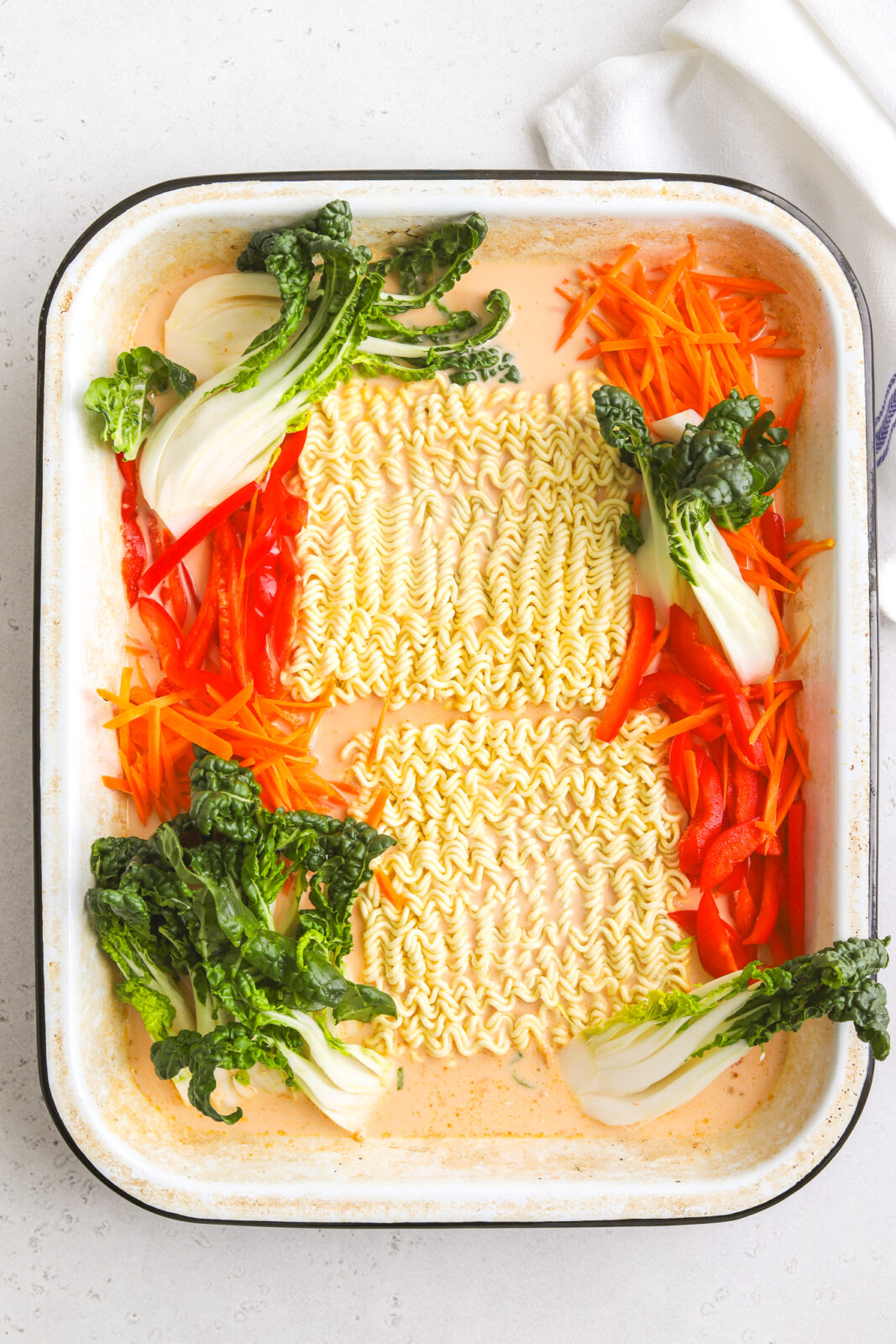 ramen noodles and vegetables in a baking dish