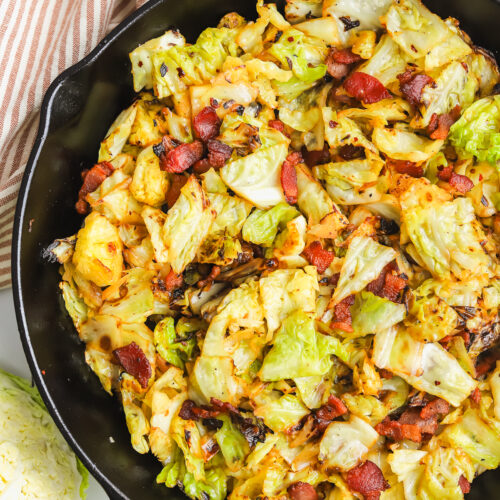 savoy cabbage and bacon sauteed in a cast iron pan